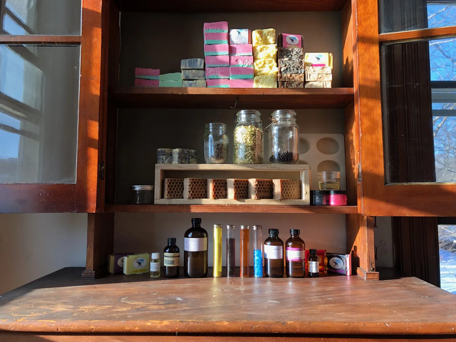 Handmade soaps and ingredients displayed in the workshop